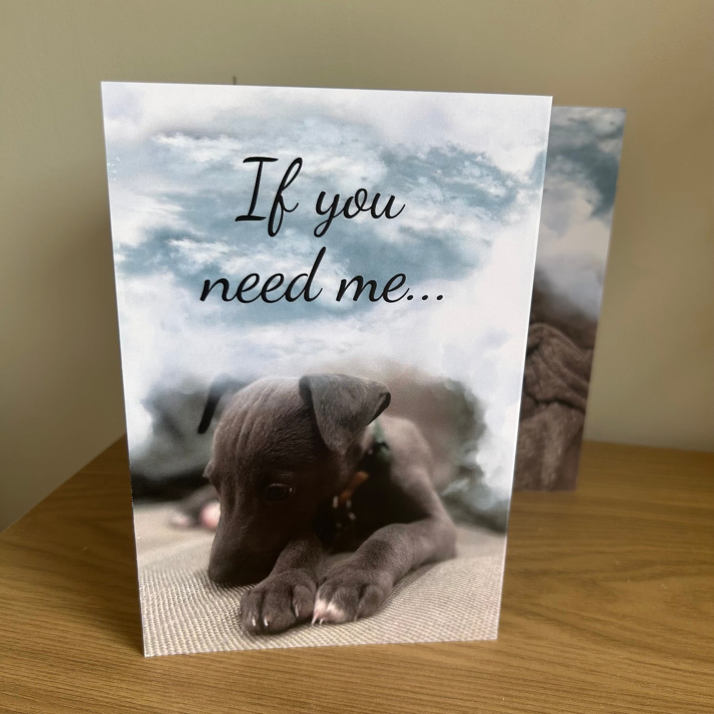 The image shows a photo of the front of the Bare Cards Dog Photo Sentiment Card 'If you need me' showing a scute whippet puppy looking forlorn under grey clouds and the words 'If you need me...'.