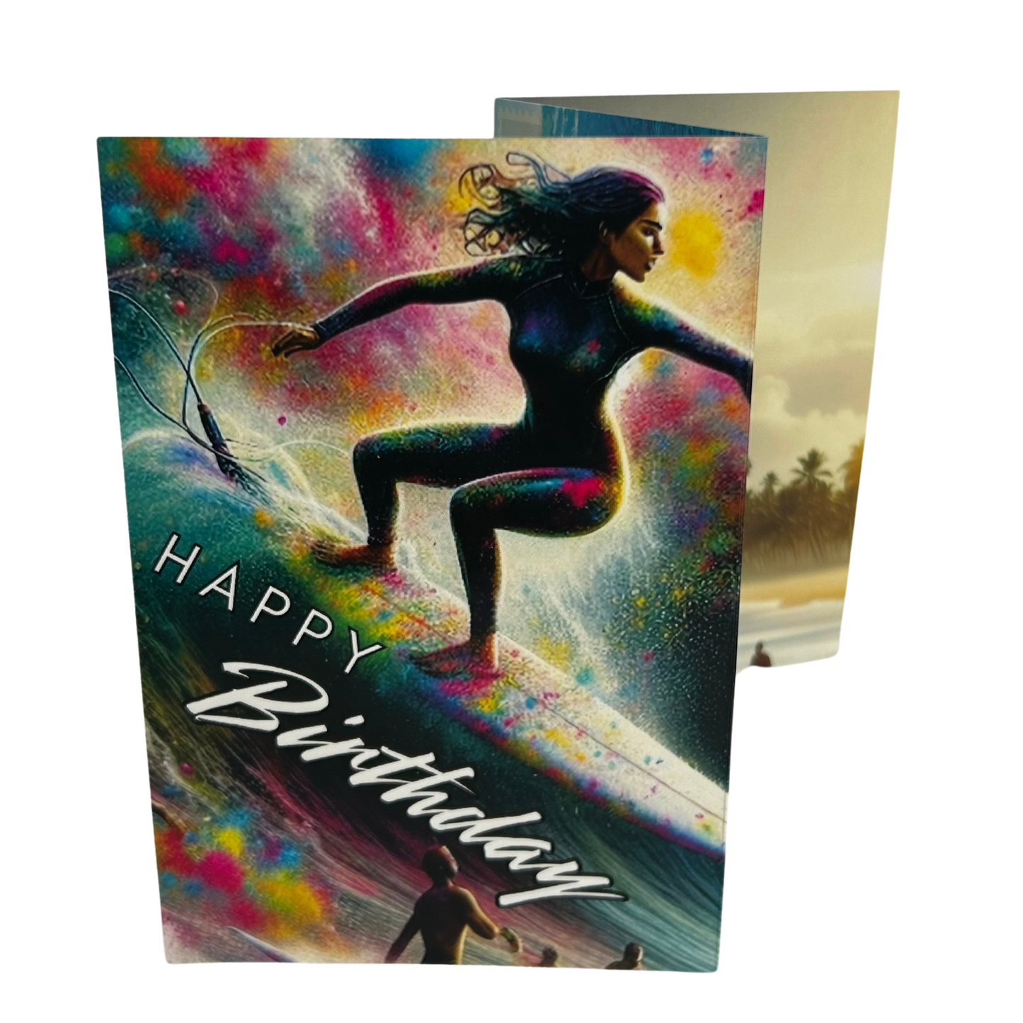 Trifold Female Surfer Birthday Card from the Push the Limit Range. Image shows the folded card depicting front with female surfer riding a wave with other surfers watching on and a background of colouful paint splatters. The caption reads 'Happy Birthday'.