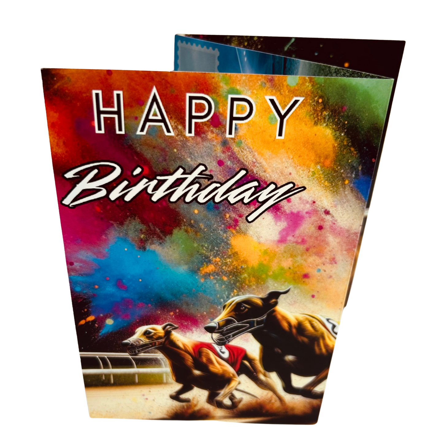 Trifold Greyhound Racing Birthday Card from the Push the Limit Range. Image shows the folded card depicting front with two brown racing greyhounds with racing jackets on running on a sand running track and a background of colouful paint splatters. The caption reads 'Happy Birthday'.
