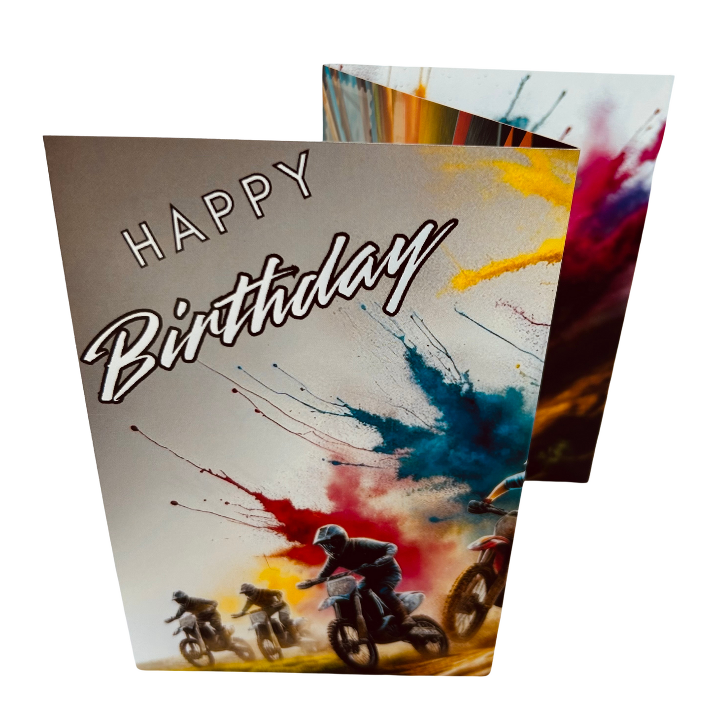 Trifold Motocross Birthday Card from the Push the Limit Range. Image shows the folded card depicting front with four dirt bike racers speeding across the terrain and a background of colouful paint splatters emerging from behind them. The caption reads 'Happy Birthday'.