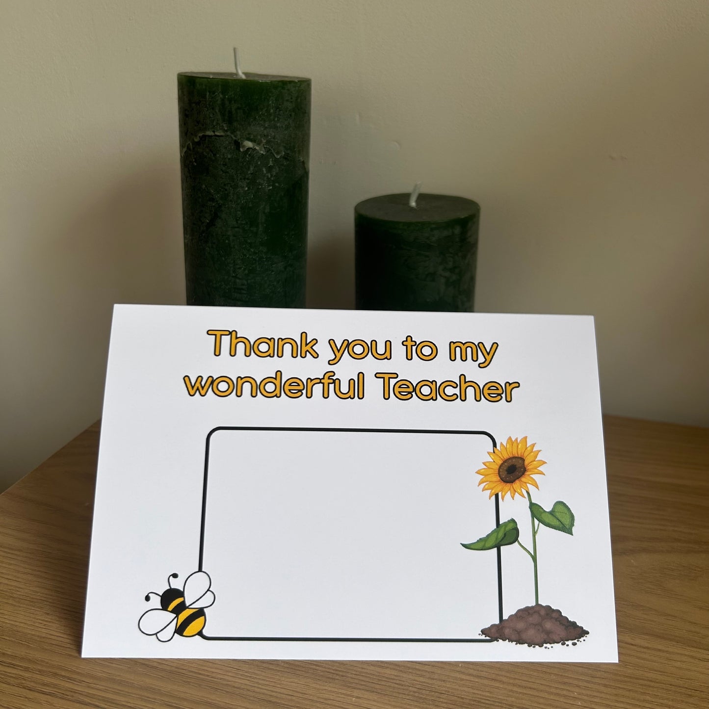Bare Cards Thank you teacher card. Photo shows the front of the built in envelope pages with the caption 'Thank you to my wonderful teacher' on the front with a space to write teacher name and images of a sunflower and a bee.