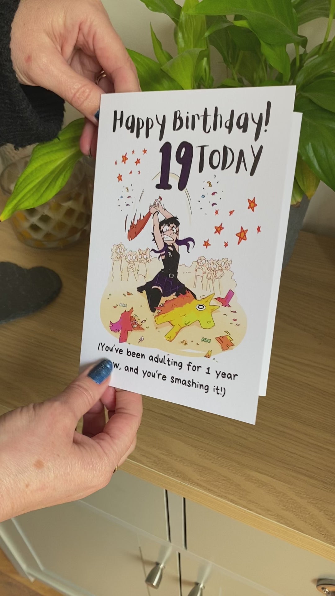 The video shows the Bare Cards 19th Birthday card perfect for the goth girl. Picture on card shows a gothic girl in black and purple about to smash a pinata with all her might whilst startled party goers look on. The caption reads "Happy Birthday! 19 Today. You've been adulting for 1 year now, and you're smashing it!"
The video goes on to demonstrate how to fold the third leaf of this unique card over to form the "envelope" - saving on single-use paper waste!
