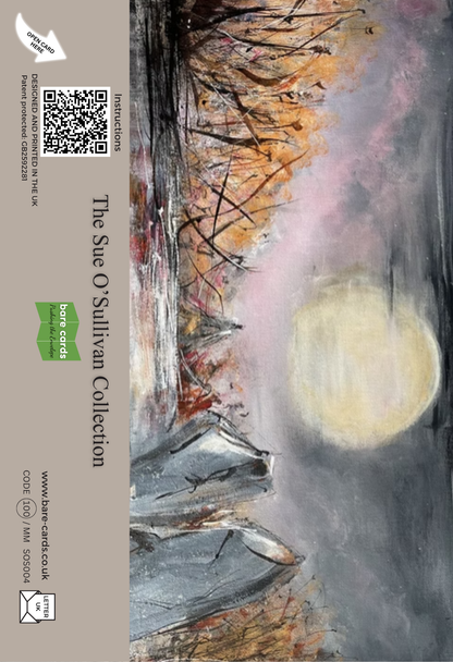 The back panel of a self-sealing greetings card featuring a moonlit landscape painting with a large pale moon, dark silhouetted trees, and pink-gray sky, displayed standing on a wooden surface. The left side has a gray printed border with text reading 'The Sue O'Sullivan Collection' and a green Bare Cards logo.