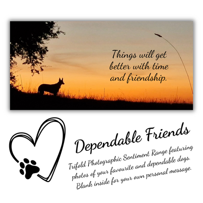 The image depicts the Bare Cards Dog Photo Sentiment Card with the full trifold image open showing a silhouette of a dog under a tree on a sunset background. The caption on the card reads 'Things will get better with time and friendship.'
Below is the Dependable Friends logo, a black outline of a heart with a dog paw. The words read 'Dependable Friends. Trifold Photographic Sentiment Range featuring photos of your favourite and dependable dogs. Blank inside for your own message