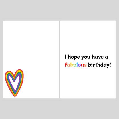 Imag shows the inside of the Bare Cards LGBT Birthday cards with a rainbow heart on the left page and the text 'I hope you have a fabulous birthday' on the right page. The word fabulous is written in rainbow colours. the image is on a grey background.