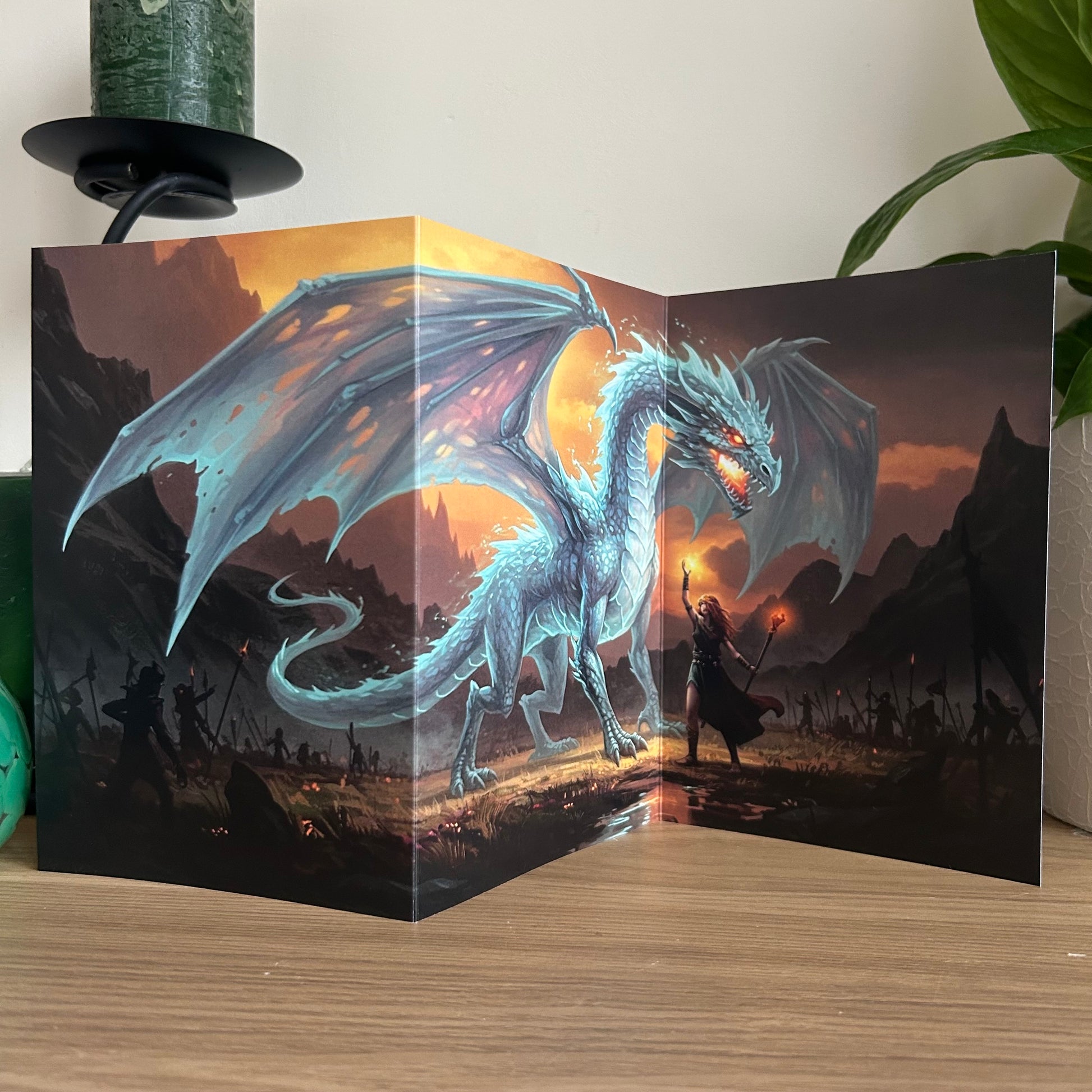 3D dragon card with a fantasy scene on a wooden surface