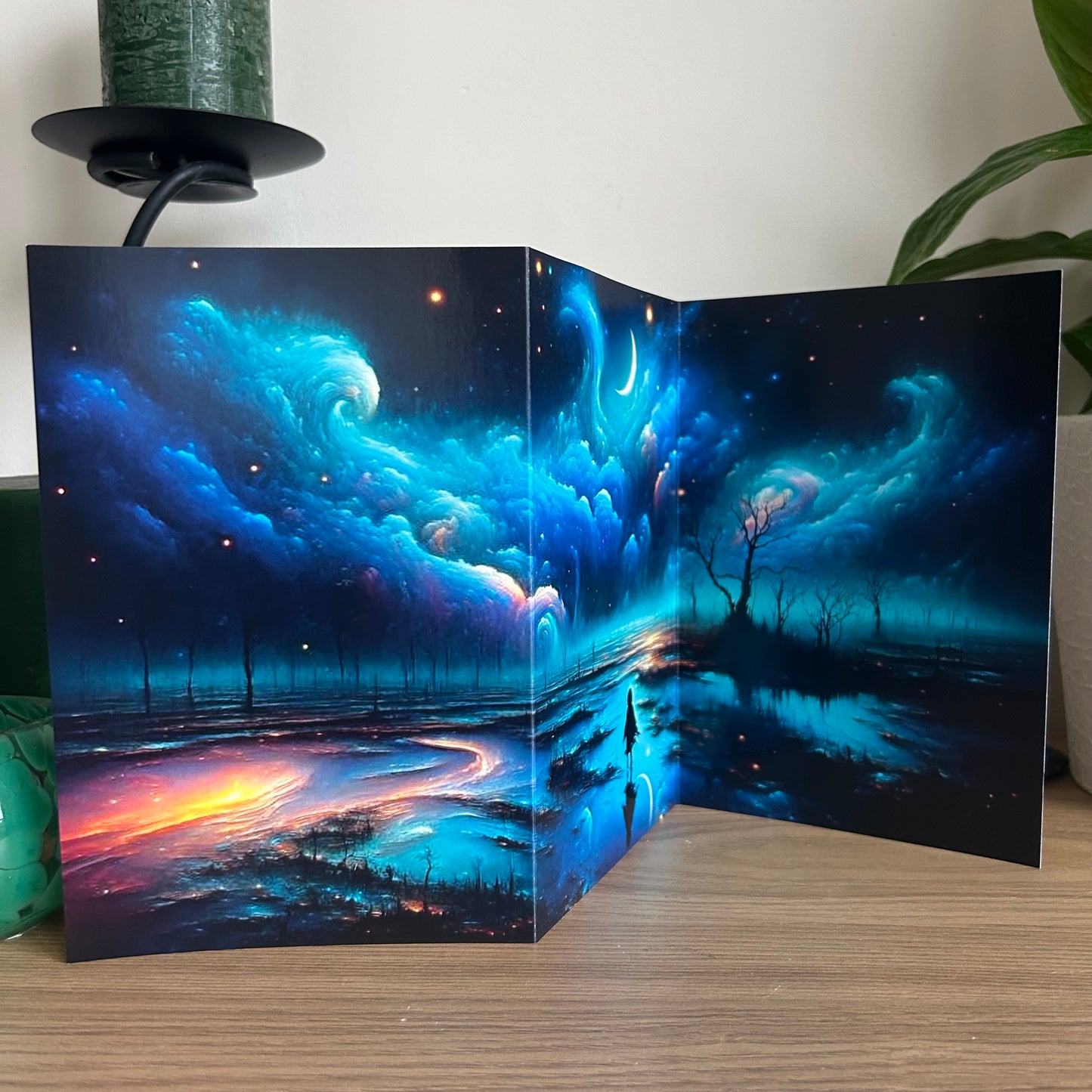 Futuristic landscape with blue skies and trees reflected in water, displayed on a stand.