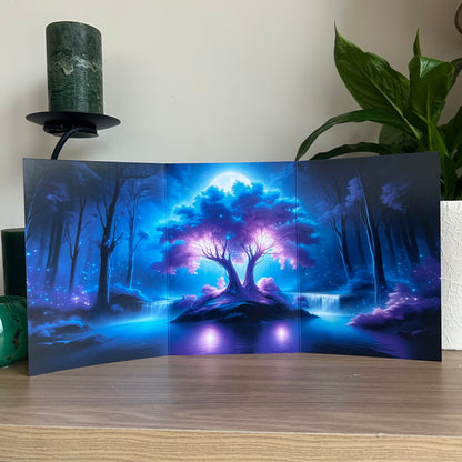 Folding card with a fantasy forest design on a wooden surface.