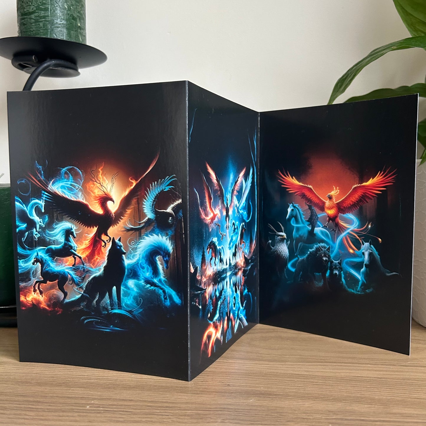 Tri-fold card with a phoenix design on a wooden surface