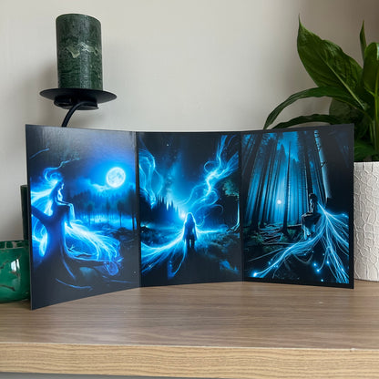 Triptych artwork with blue glowing elements on a wooden surface.