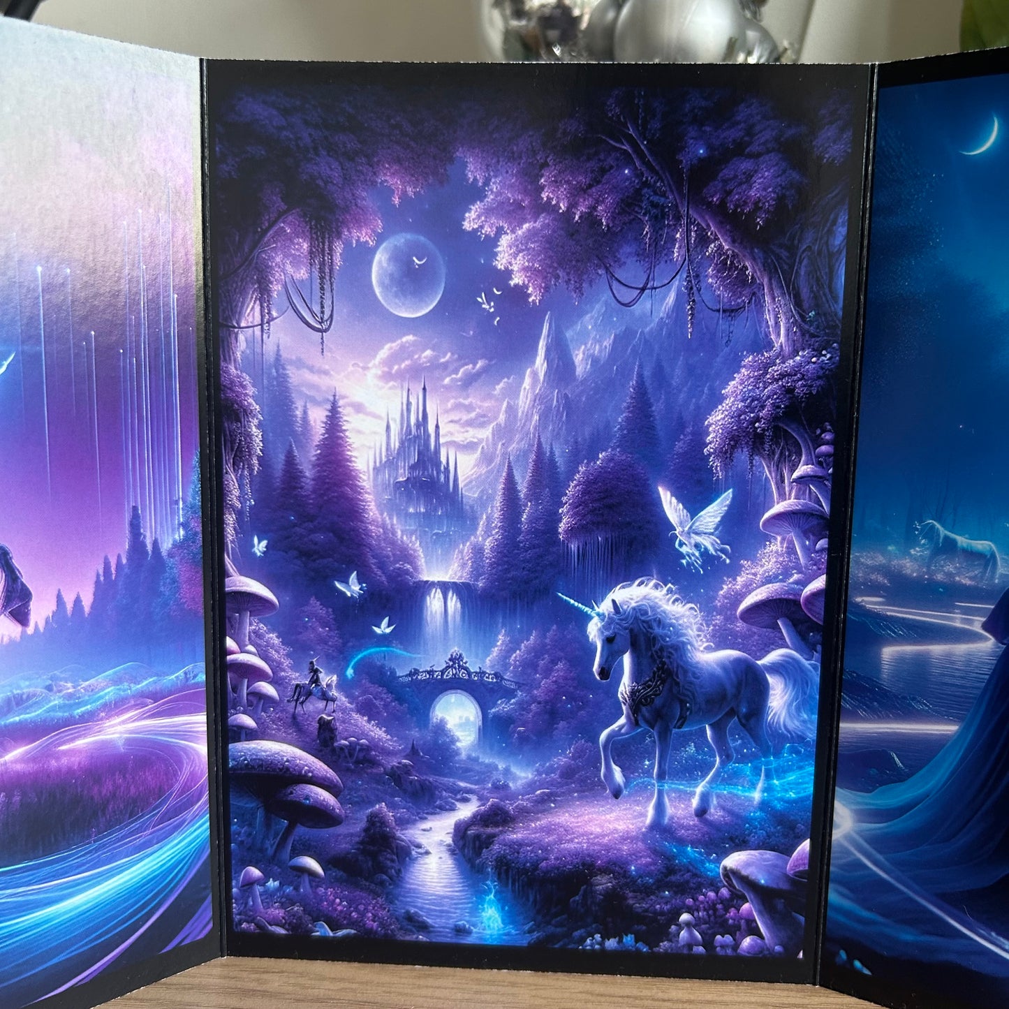 Framed artwork of a unicorn in a fantasy landscape with trees and a castle.