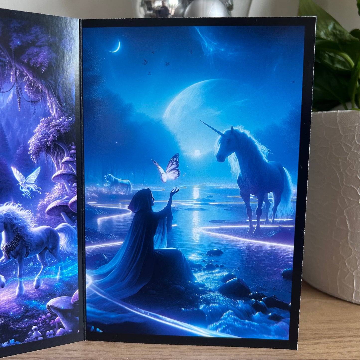 Framed artwork with a fantasy scene featuring unicorns and a person in a robe, set against a blue and purple background.