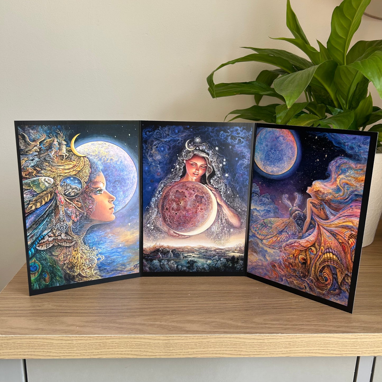 Three-panel self-sealing greetings card UK with artistic fantasy designs featuring Josephine Wall paintings of the moon goddess Diana and mystical moon paintings on a wooden surface