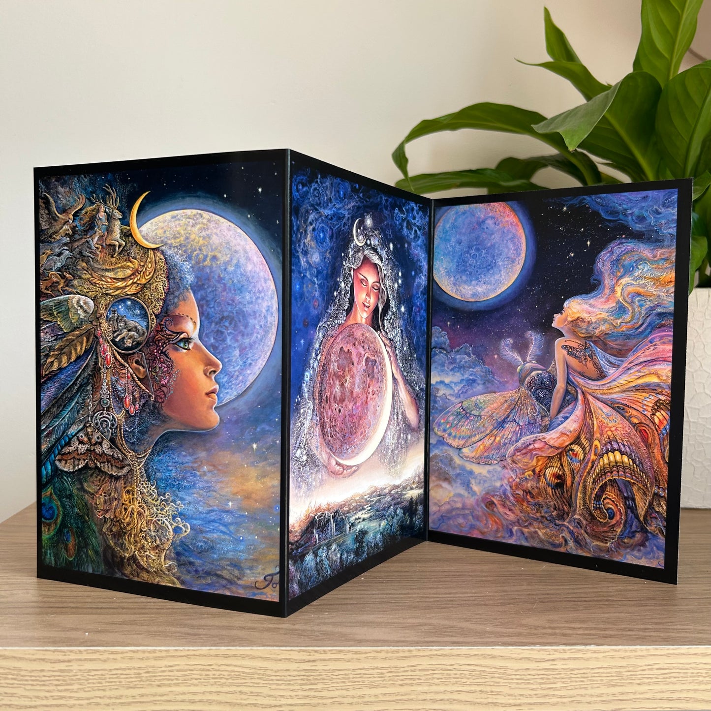 Three-panel self-sealing greetings card UK with artistic fantasy designs featuring Josephine Wall paintings of the moon goddess Diana and mystical moon paintings on a wooden surface