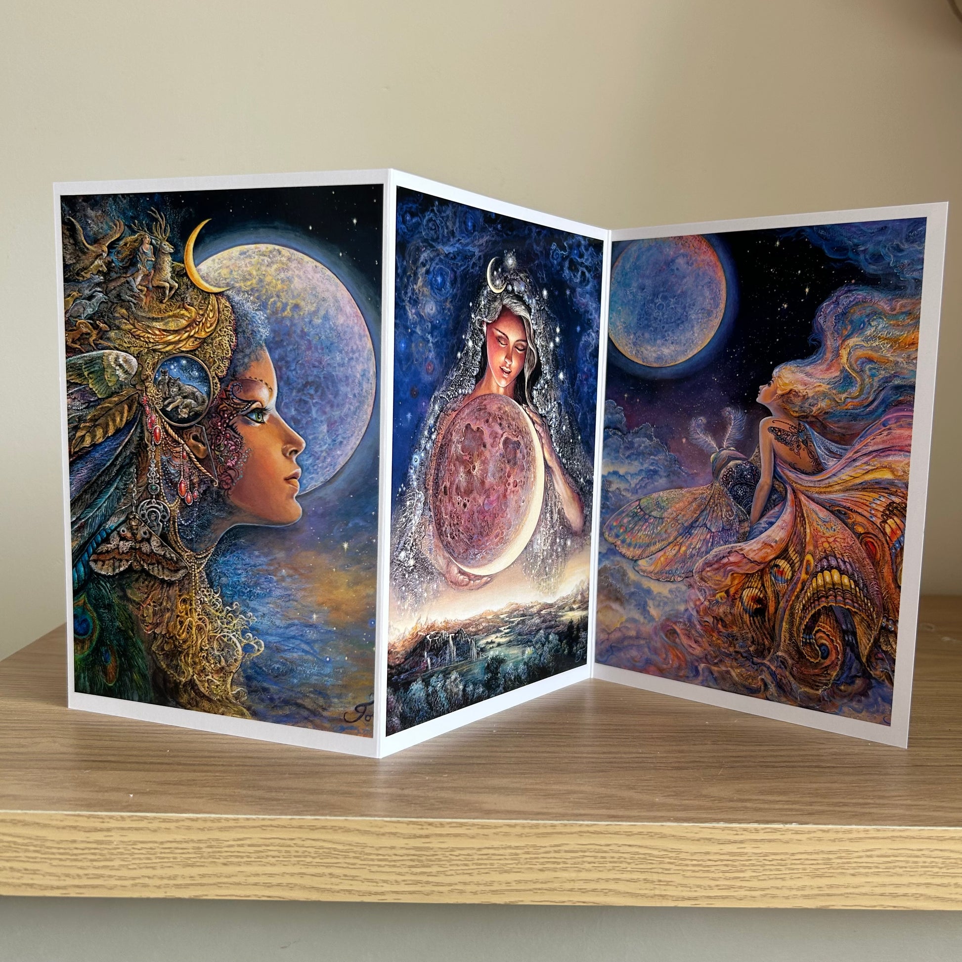 Three-panel self-sealing greetings card UK with artistic fantasy designs featuring Josephine Wall paintings of the moon goddess Diana and mystical moon paintings on a wooden surface