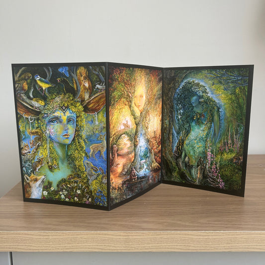 Three-panel self-sealing greetings card UK with artistic fantasy designs featuring Josephine Wall paintings of nature and mystical figures on a wooden surface