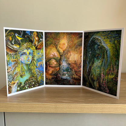 Three-panel self-sealing greetings card UK with artistic fantasy designs featuring Josephine Wall paintings of nature and mystical figures on a wooden surface