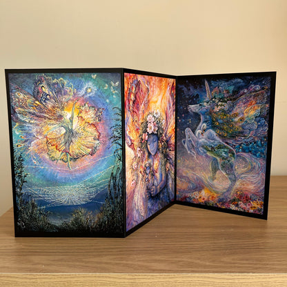 Three-panel self-sealing greetings card UK with artistic designs of a unicorn and fairy figures on a wooden surface.