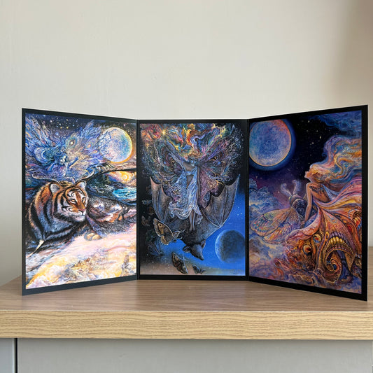 Three-panel self-sealing greetings card UK with artistic designs of fairy figures riding animals to the moon on a wooden surface.