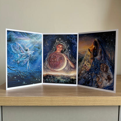 Three-panel self-sealing greetings card UK with artistic fantasy designs featuring Josephine Wall paintings of the moon and mystical fairies and goddesses on a wooden surface