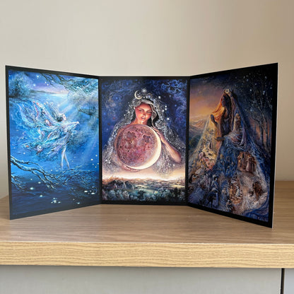Three-panel self-sealing greetings card UK with artistic fantasy designs featuring Josephine Wall paintings of the moon and mystical fairies and goddesses on a wooden surface
