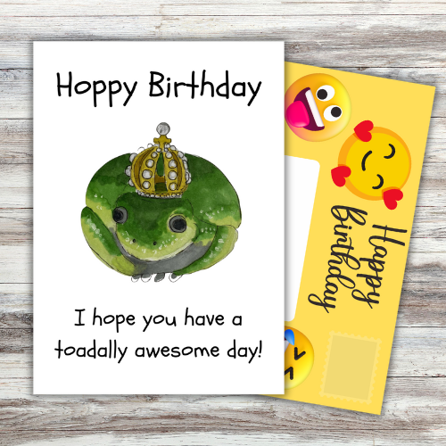 Image shows front of card which reads 'Hoppy Birthday. I hope you have a toadally awesome day' with a picture of a green toad wearing a crown. Yellow fully-illustrated Front posting page is sticking out behind card.