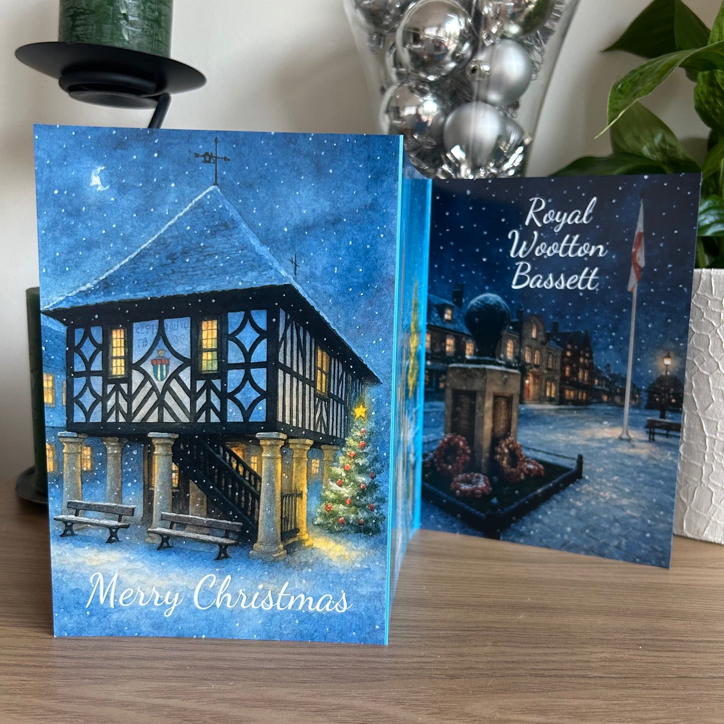 Christmas card with a snowy village scene and 'Royal Wootton Bassett' text.