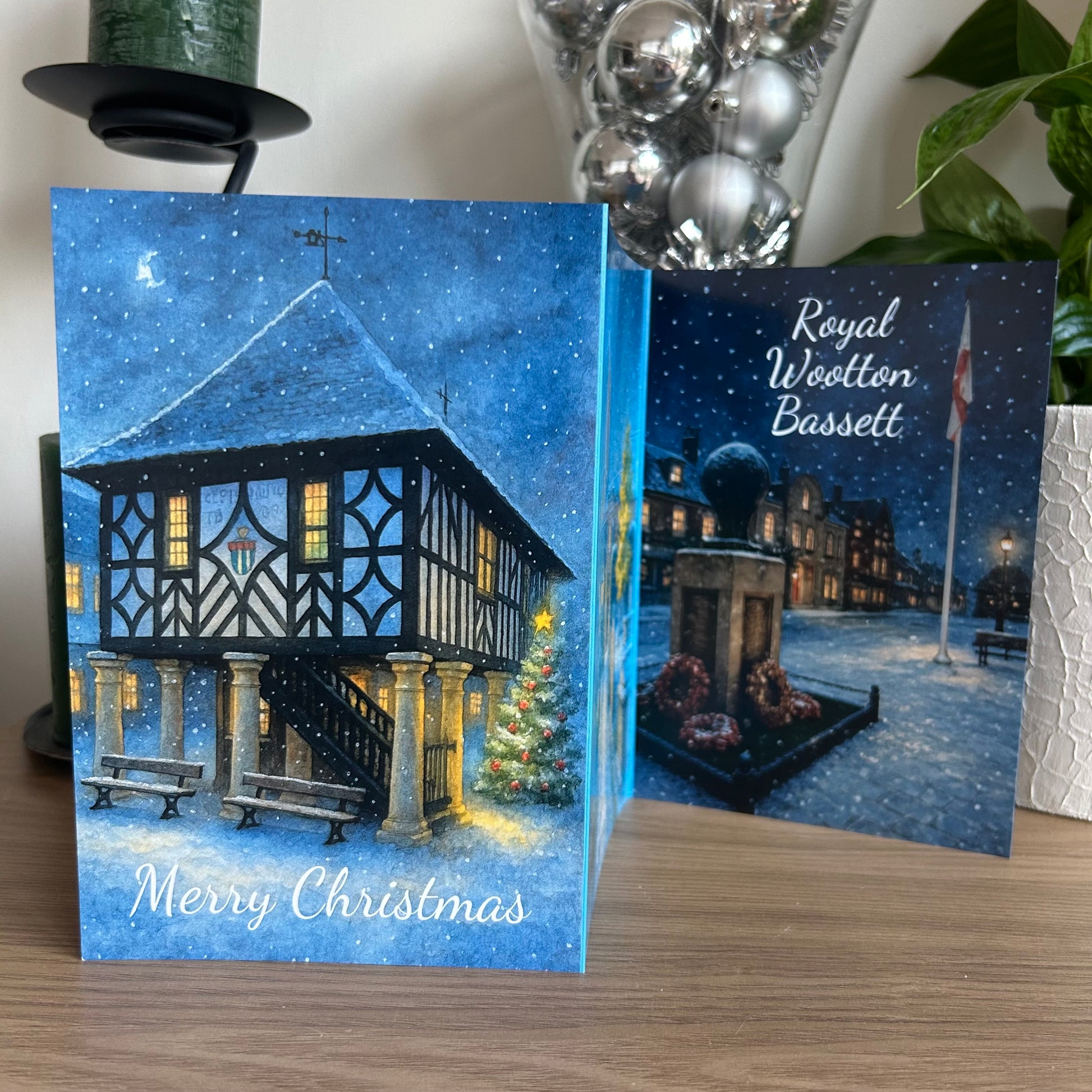 Christmas card with a snowy village scene and 'Royal Wootton Bassett' text.