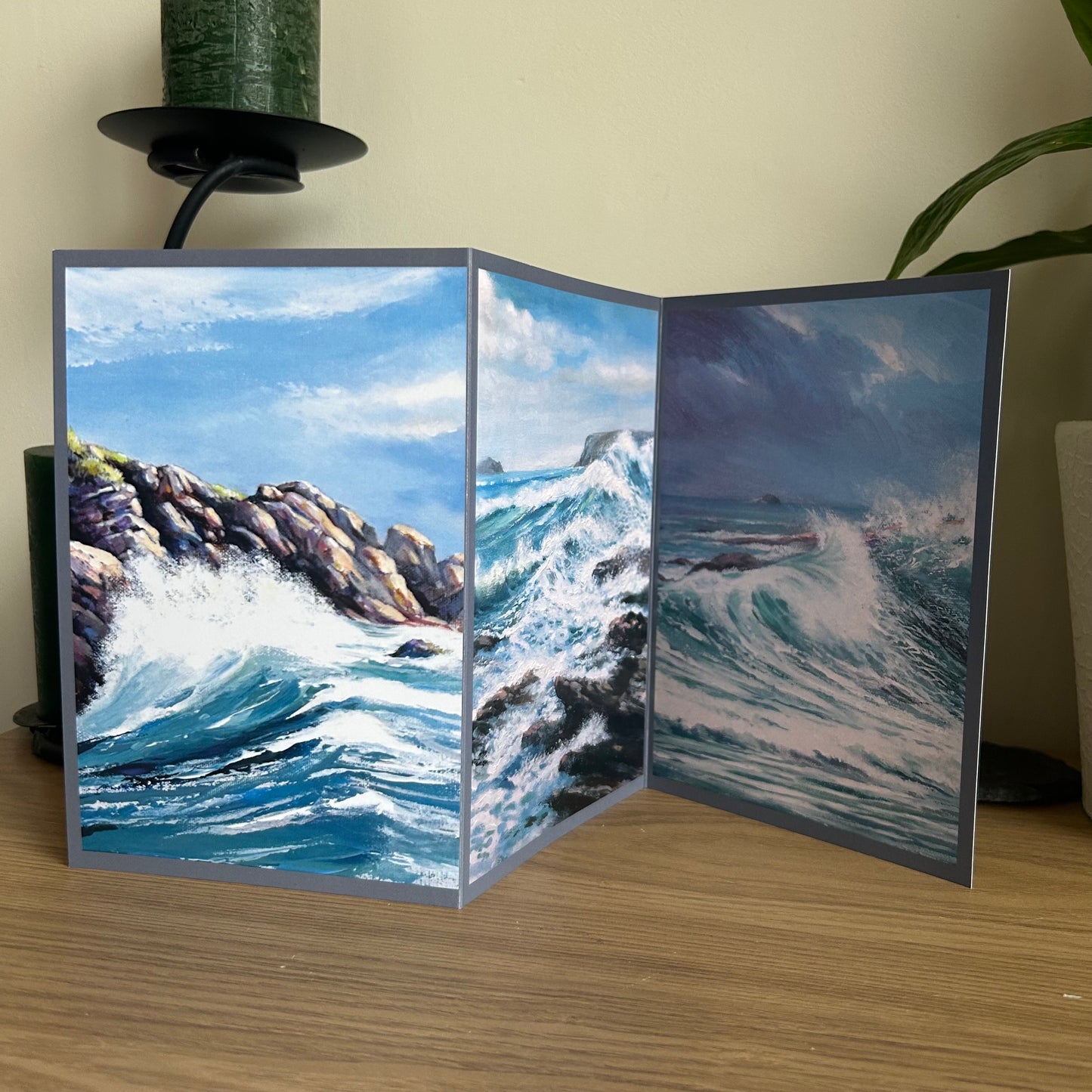 Open card with ocean scene on a wooden surface