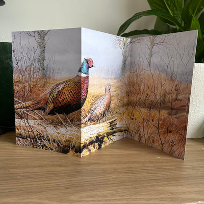 Trifold Greeting card with pheasant design on a wooden surface