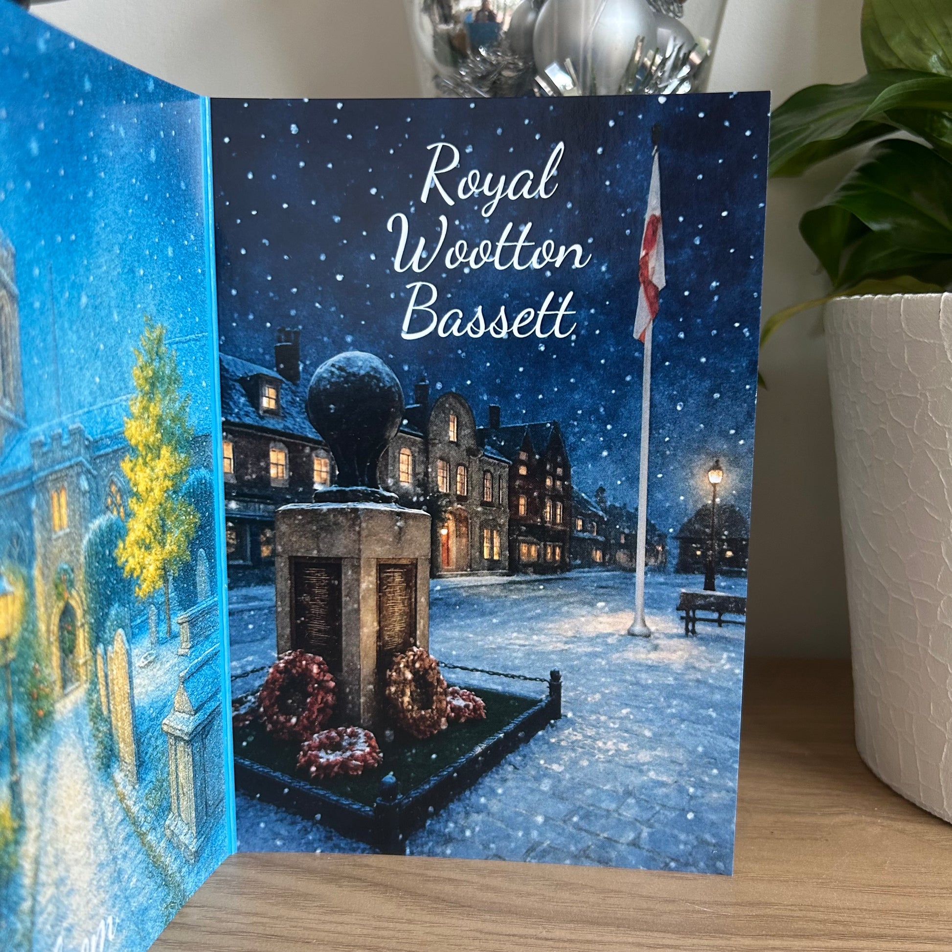 Greeting card with a snowy village scene and 'Royal Wootton Bassett' text.