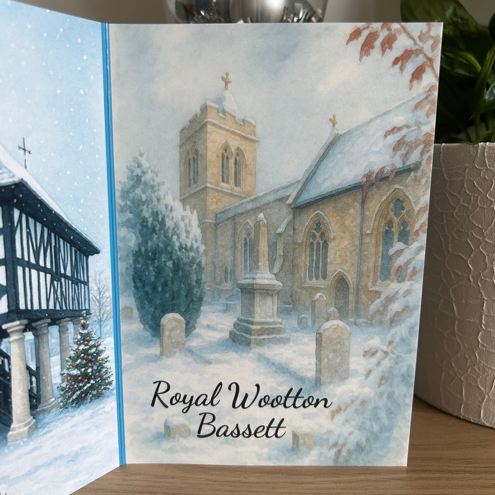 Greeting card with a snowy village scene and 'Royal Wootton Bassett' text.