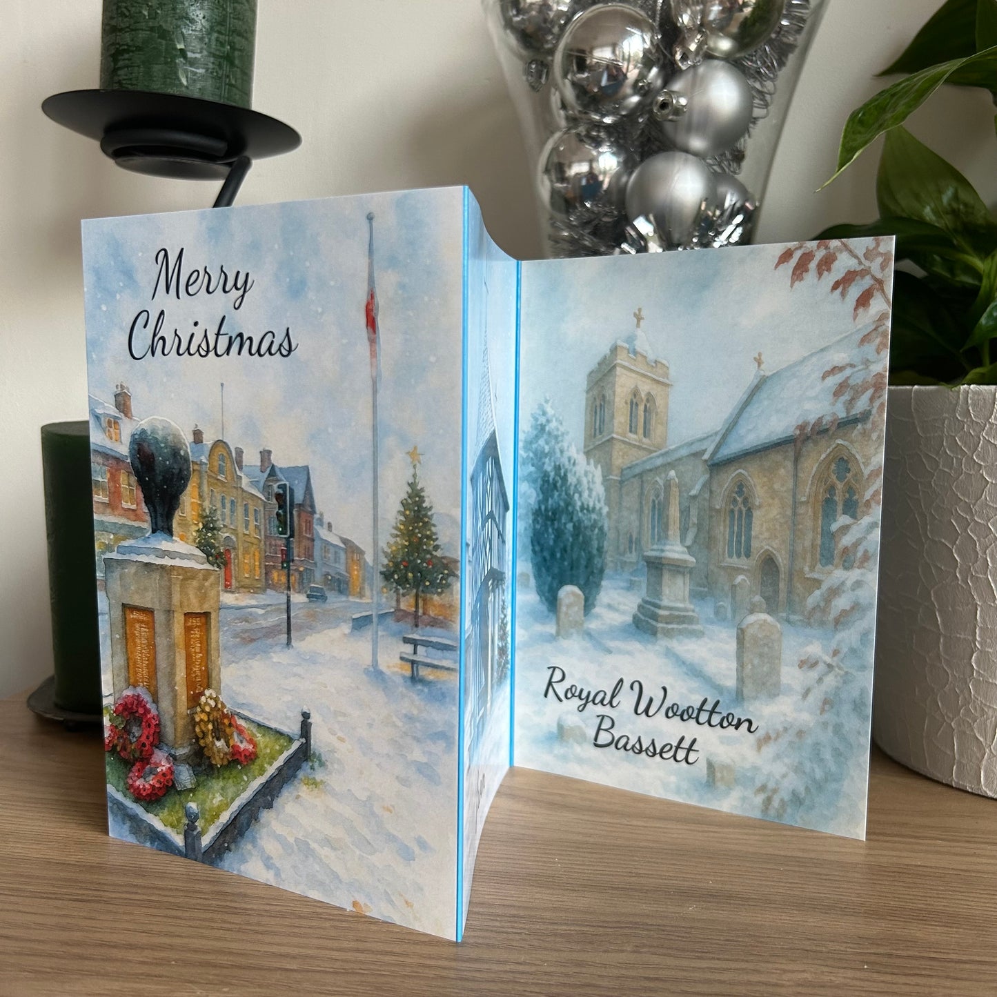 Christmas card with a snowy village scene and church, featuring 'Merry Christmas' text.