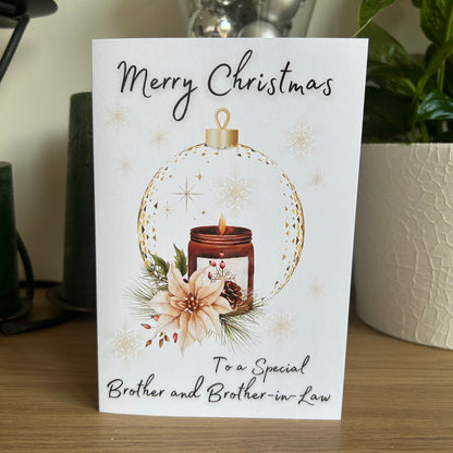 Christmas card with a candle and floral design, addressed to a special brother and brother-in-law.