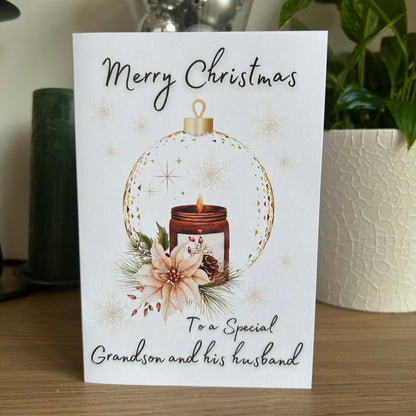 Christmas card with a candle and floral design, addressed to a special grandson and his husband.