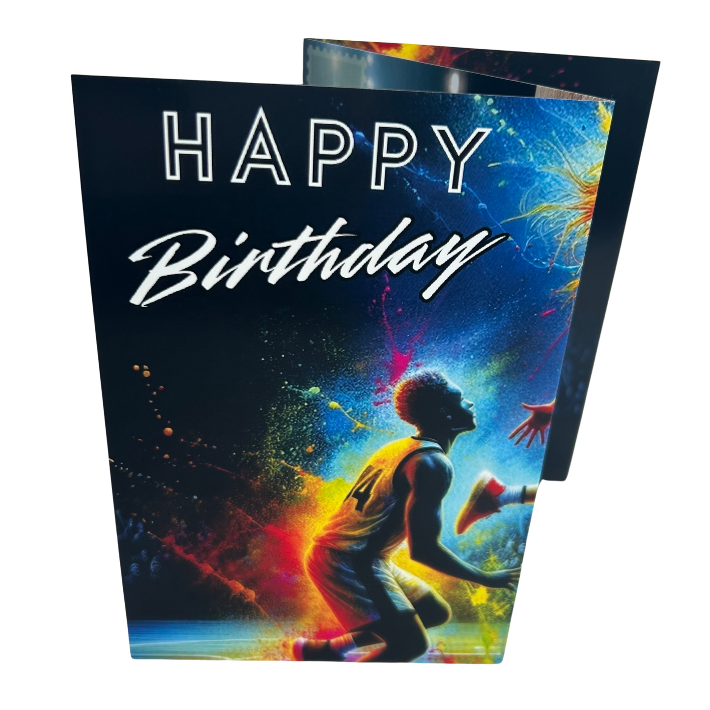 Trifold Female Basketball Birthday Card from the Push the Limit Range. Image shows the folded card depicting front with male basketball player watching up and a background of colouful paint splatters and mountain snow, trees and ski lift. The caption reads 'Happy Birthday'.