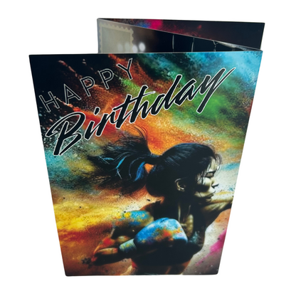 Trifold Female Birthday Card from the Push the Limit Range. Image shows the folded card depicting front with a female boxer giving a strong right punch and a background of colouful paint splatters. The caption reads 'Happy Birthday'.