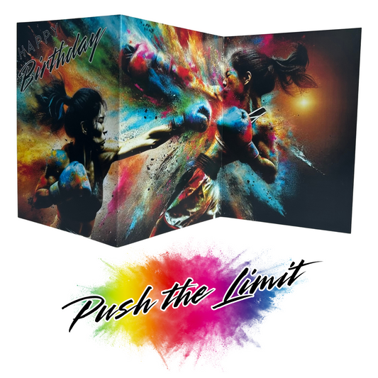 Main product image shows all three leaves of the trifold birthday card for Female Boxing. Card shows two female boxers fighting it out with blue boxing gloves on both throwing strong punches with determined looks on their faces, all on a black background with an explosion of colourful paint splatters emerging from behind them. The caption on the card reads 'Happy Birthday'. Beneath this is the Push the Limit logo with the words displayed on a multicoloured paint splatter.