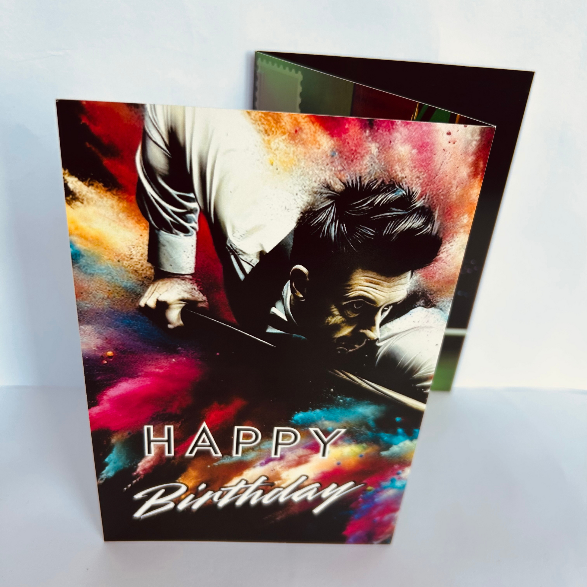 Trifold Snooker Birthday Card from the Push the Limit Range. Image shows the folded card depicting front with man about to strike the cueball with colouful paint splatters in the background and caption reads 'Happy Birthday'.