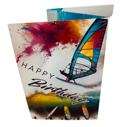Trifold Windsurfing Birthday Card from the Push the Limit Range. Image shows the folded card depicting front with windsurfer jumping a wave on a background of colouful paint splatters whilst other windsurfers watch on with their boards and sails . The caption reads 'Happy Birthday'