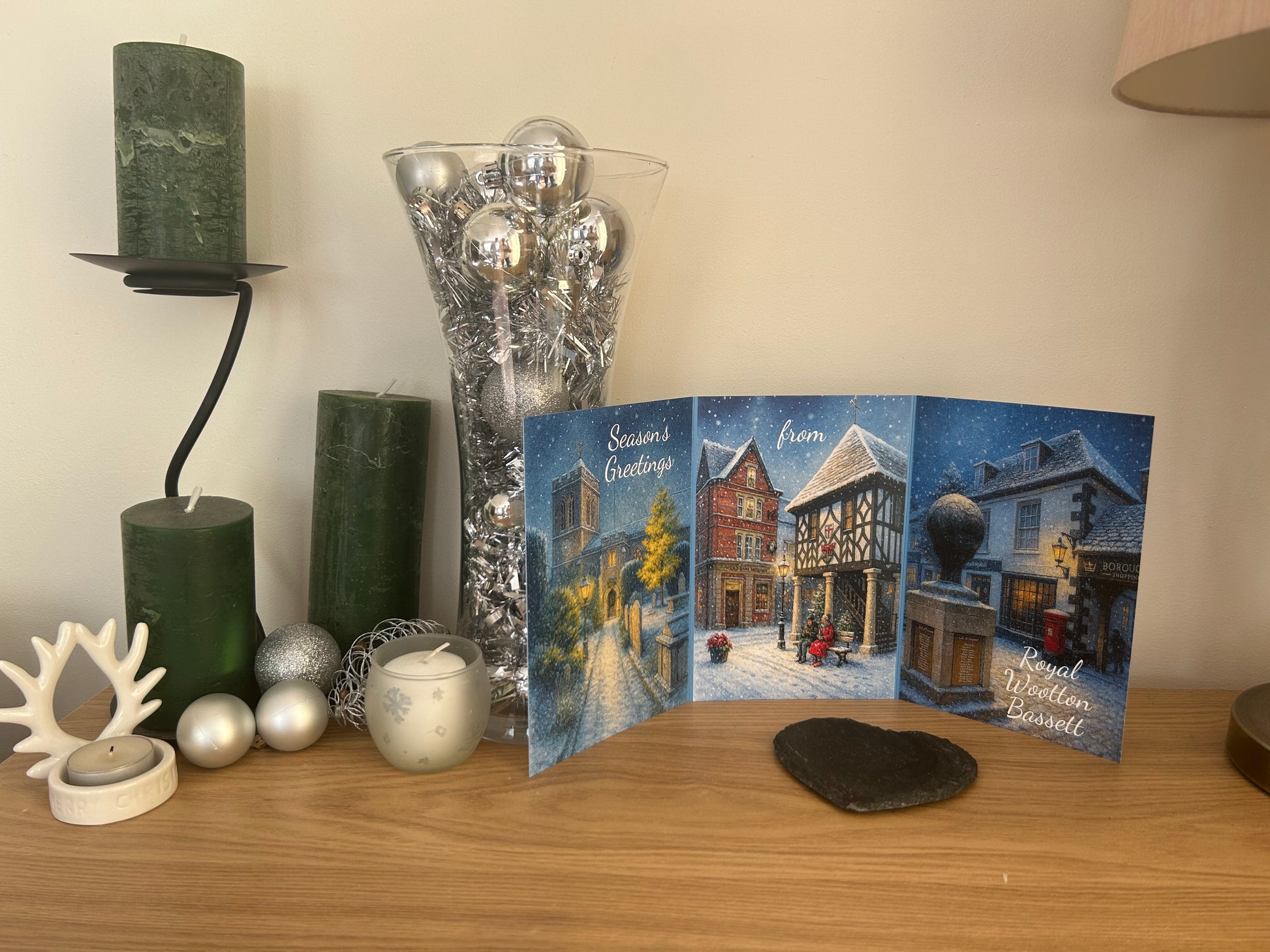 Photo of trifold Christmas card displayed in christmas home setting
