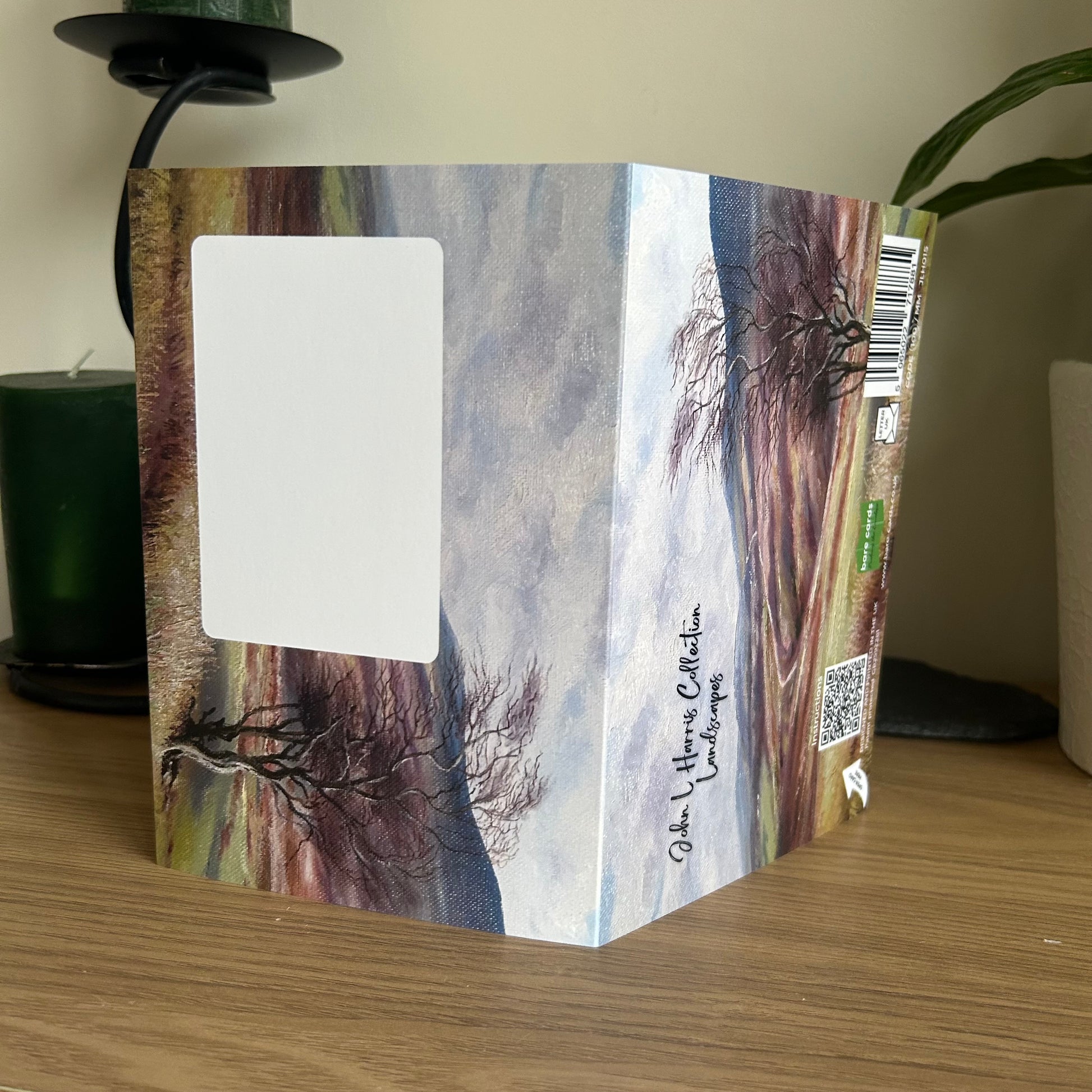 Self-sealing envelope panels for the John L Harris landscape greetings cards with nature-themed cover on a wooden surface