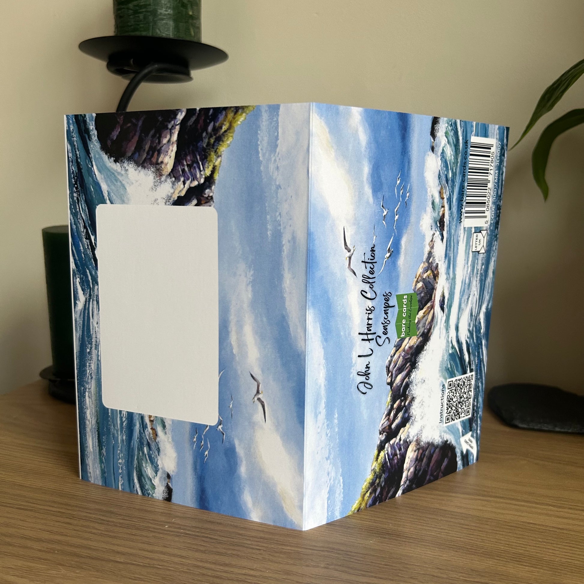 Envelope panels for the self-sealing greetings cards in the John L Harris seascapes collection with seascape design on a wooden surface