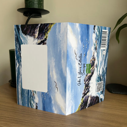 Envelope panels for the self-sealing greetings cards in the John L Harris seascapes collection with seascape design on a wooden surface