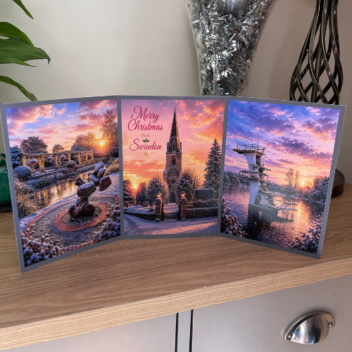 Bare Cards Self-sealing Triptych Christmas Card for Swindon, showing festive images of Queen's Park, Christchurch and Coate Water at dusk.