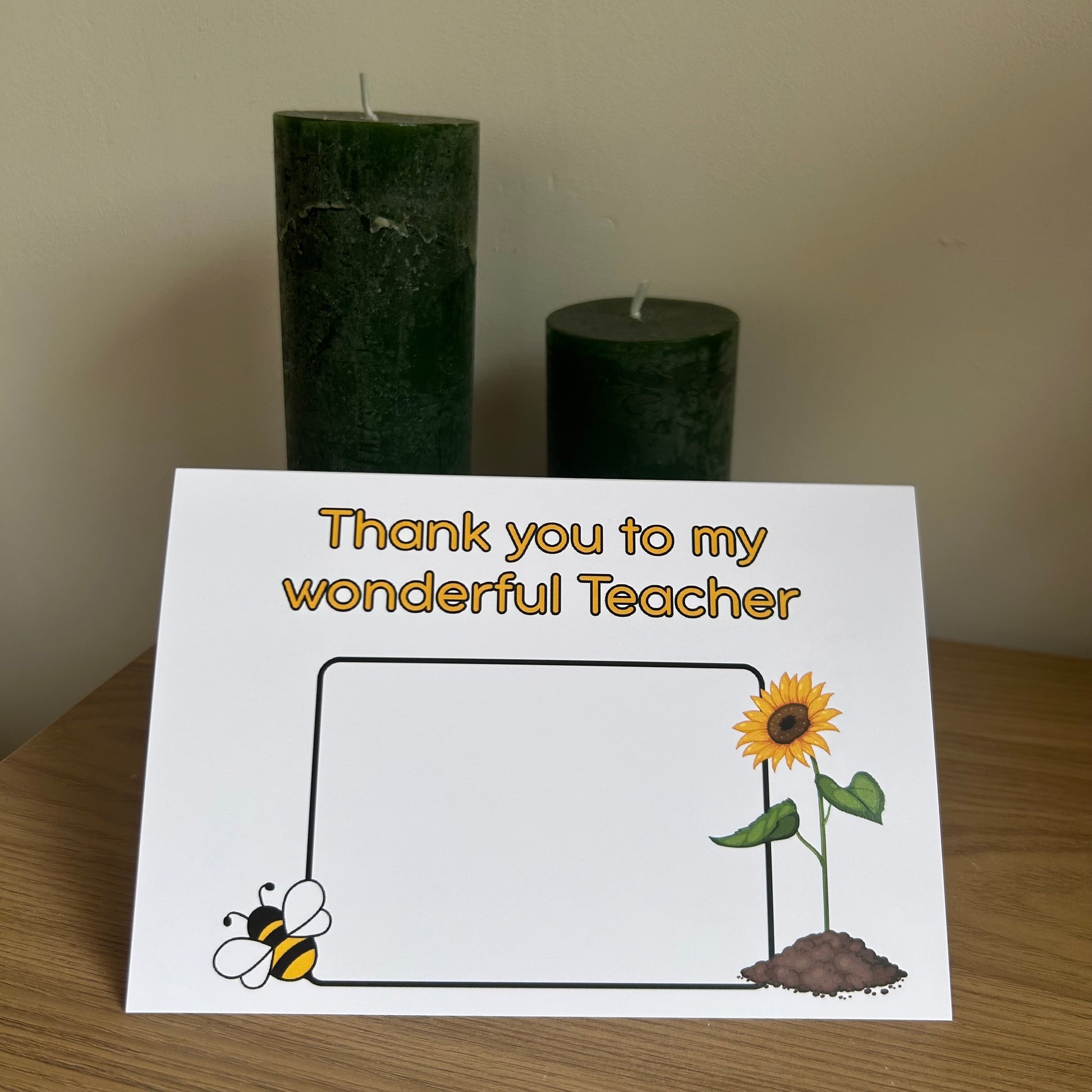 Bare Cards Thank you teacher card. Photo shows the front of the built in envelope pages with the caption 'Thank you to my wonderful teacher' on the front with a space to write teacher name and images of a sunflower and a bee. 