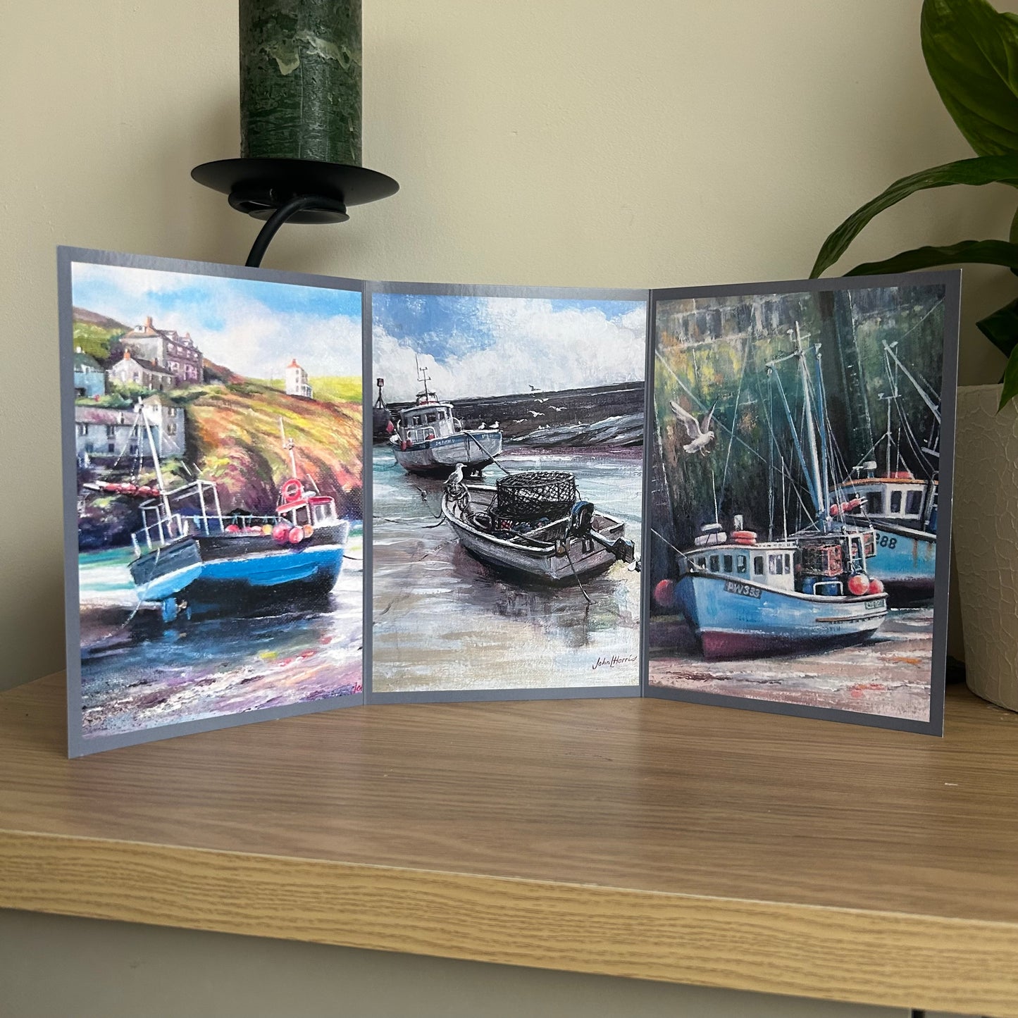 Tri-fold greetings card with images of boats on a wooden surface
