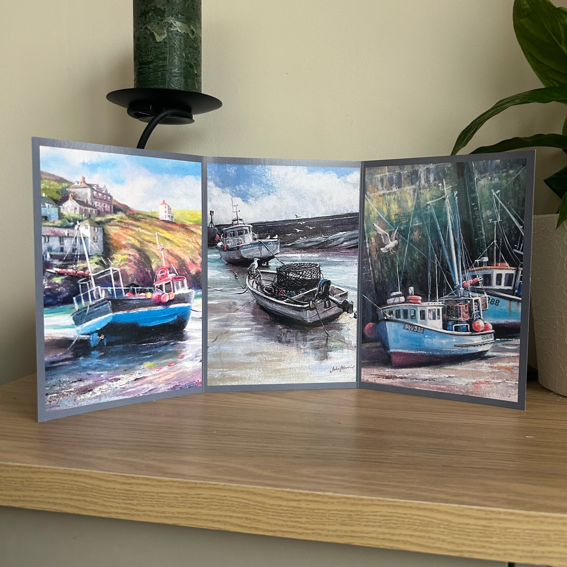Tri-fold greetings card with images of boats on a wooden surface
