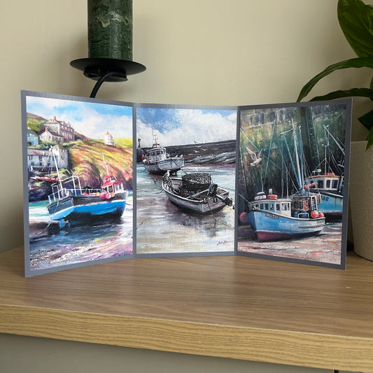 Tri-fold greetings card with images of boats on a wooden surface