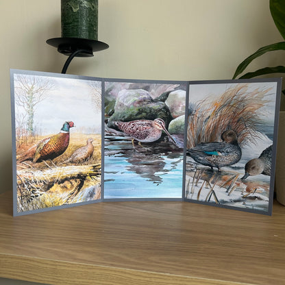 Triptych nature-themed greeting card with birds on a wooden surface.